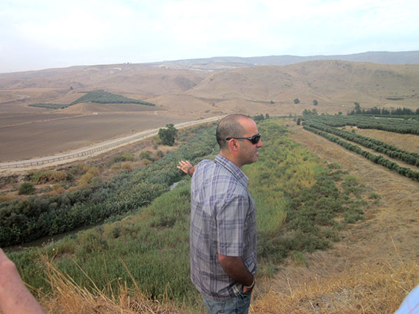 Hagai Oz shows what has become of the Jordan River to a German tour group visiting the Peace Island
Photo: Ted Swagerty