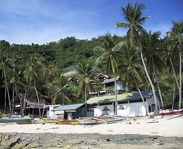 Apo Island tourist strip (hotel, dive shop, and church)