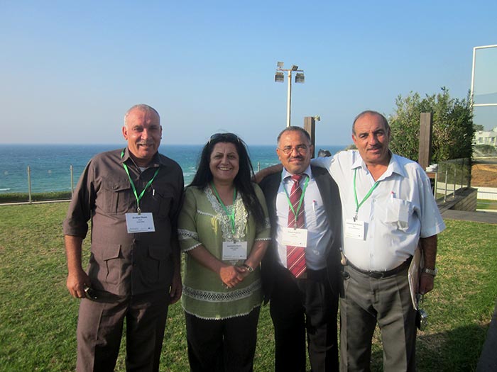 Palestinian staff members pose for a picture at the Good Water Neighbors conference in Tel Aviv.