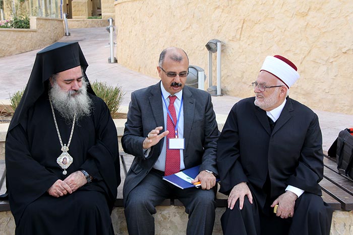 Nader Khateb, FoEME's Palestinian Director, visits with religious leaders from the region at the Jordan River conference.