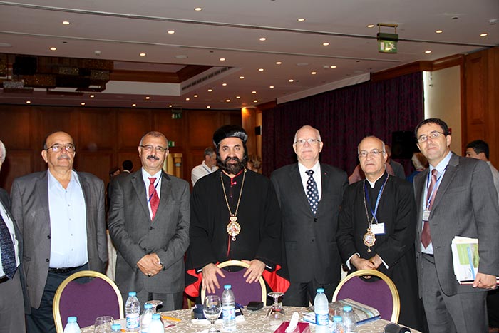 All three directors of FoEME pose for a picture with two Syrian Orthodox bishops and an Islamic community leader.